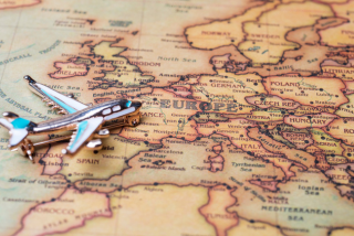 Mapa da Europa visto de perto, com um pequeno avião em miniatura pousado sobre ele